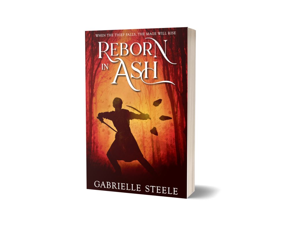 A paperback of Reborn in Ash by Gabrielle Steele. The background is dark with a red-orange glow in a gap between the silhouettes of trees. The silhouette of a person fills most of the space between the trees. They are in an action stance, with twin swords raised, one either side, curving towards them defensively. One arm extends to the right, where three pointed stones hover, their tips aimed away from the person.